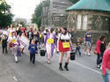 The parade passes the lodges